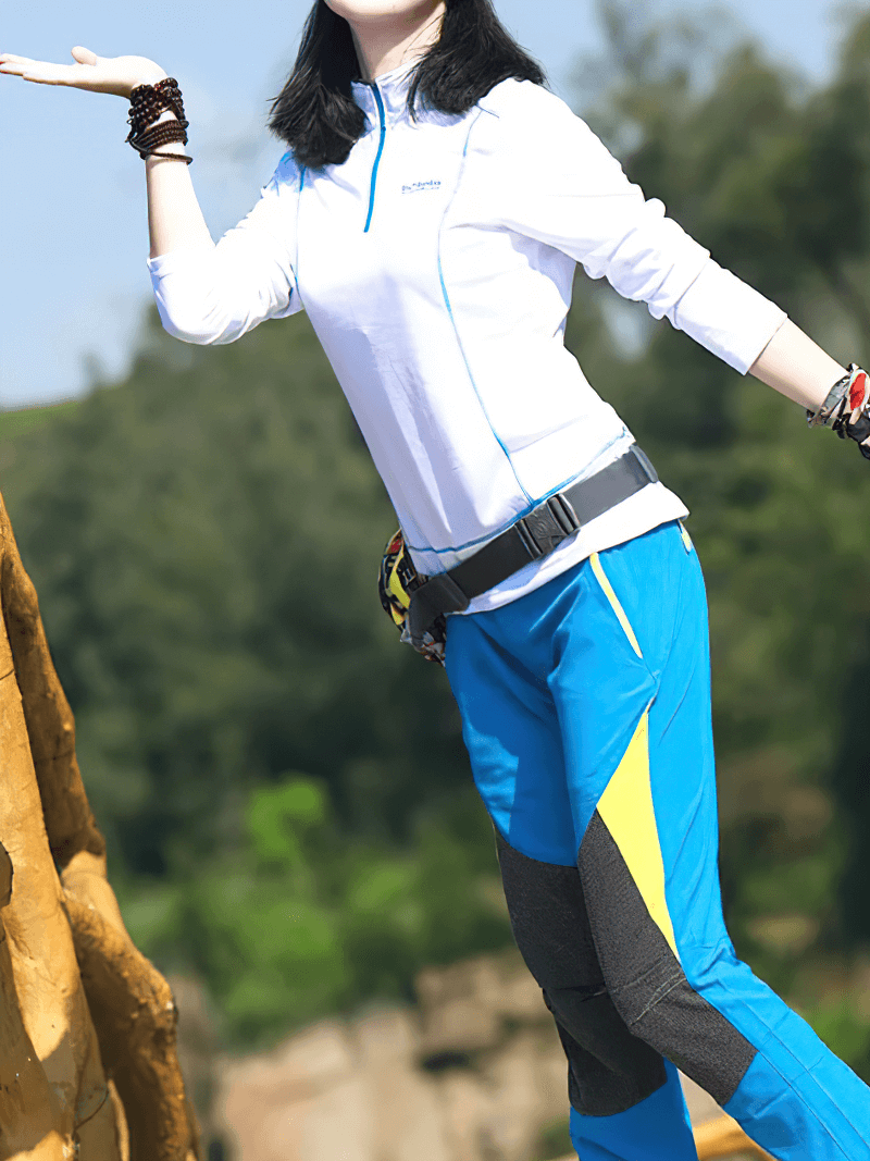Woman in a quick-drying stand-up collar top with half zip, enjoying outdoor activities in durable, stylish sportswear.